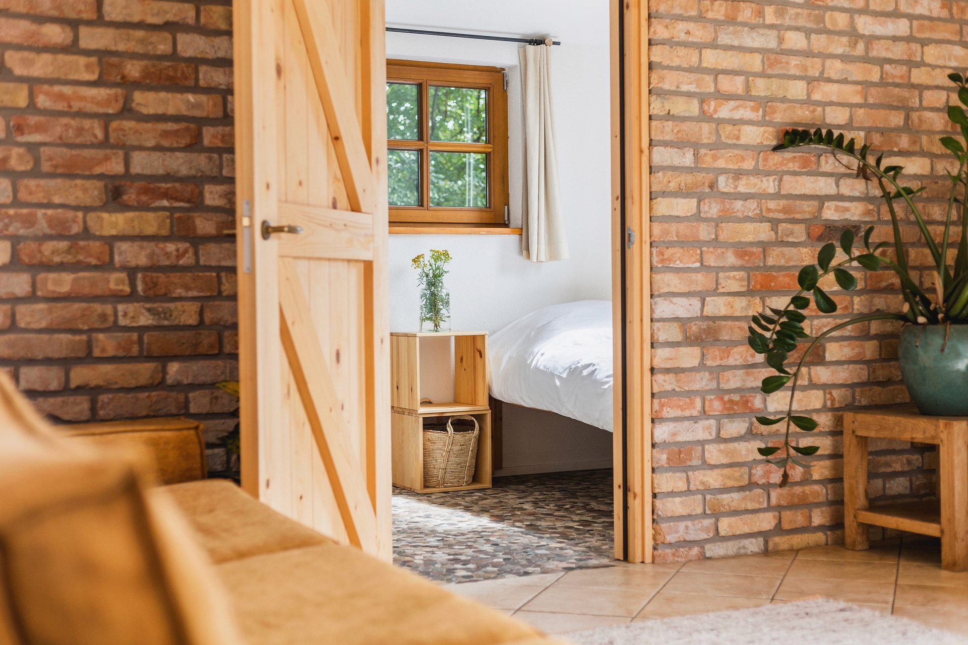 Cozy shared spaces, bedrooms and bathrooms (path through wildflowers, sign “STRAND SAUNA”)